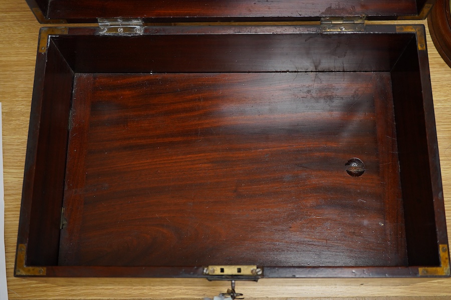 An early 19th century mahogany correspondence box with secret compartment, campaign style flush handle concealing button release, with key, 45cm wide